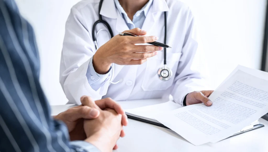 A clinician and patient reviewing a treatment plan together at a desk