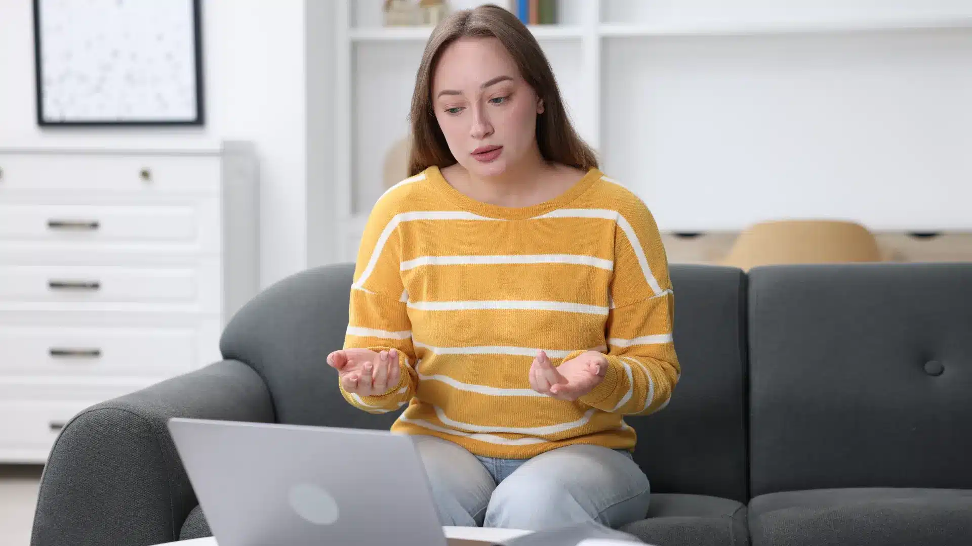 A patient at home having a telehealth consultation on a laptop