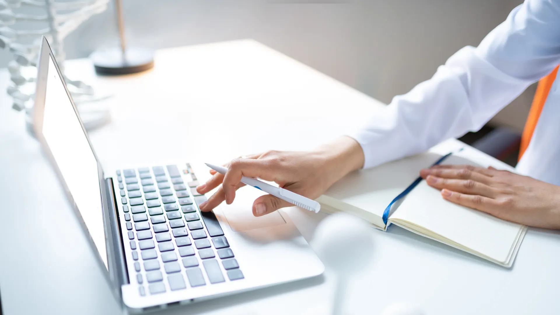 medical researcher typing on laptop