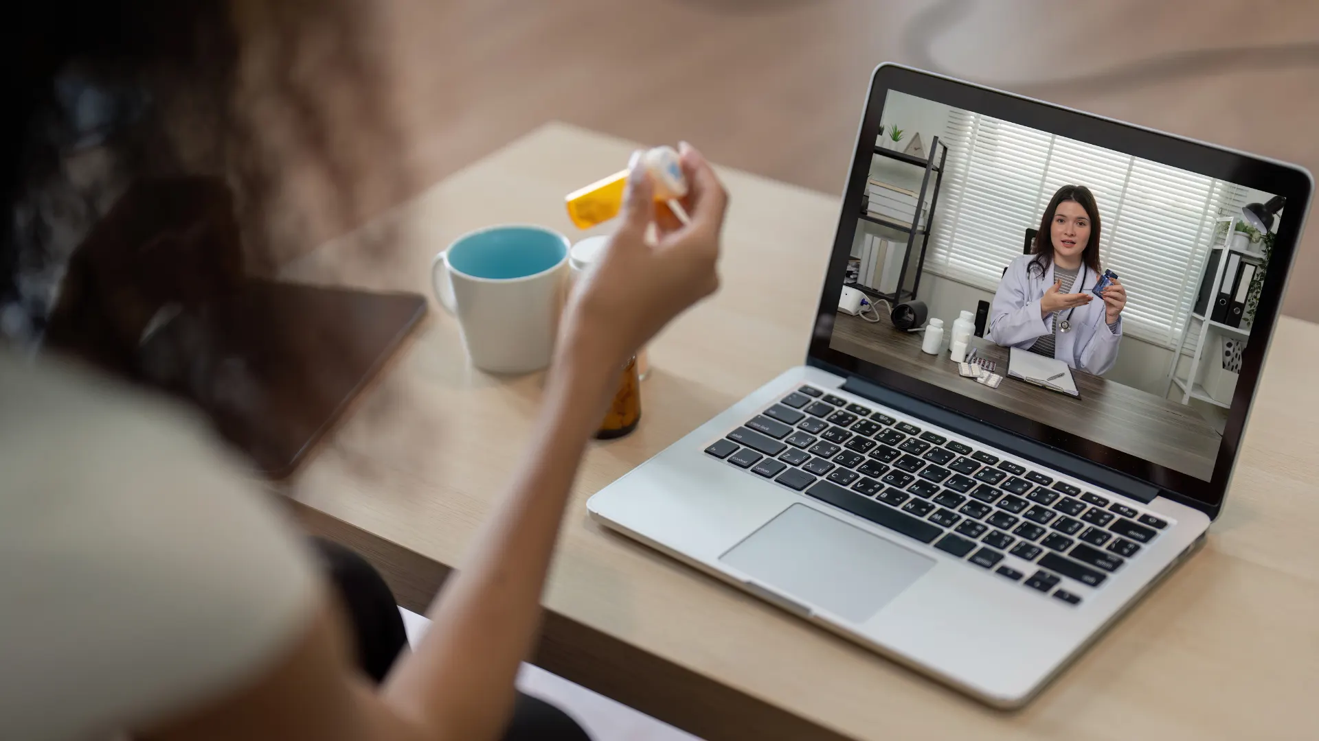 A patient at home having a telehealth consultation on a laptop