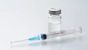 Small glass vial and syringe on a clean lab counter